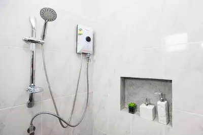 a shower with a shower head in a bathroom at comfortable BAMBOO houses in Ban Thalat Choeng Thale