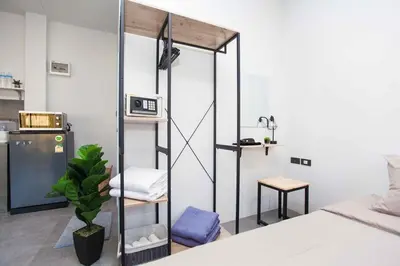 a room with a mirror and a bed and a table at comfortable BAMBOO houses in Ban Thalat Choeng Thale