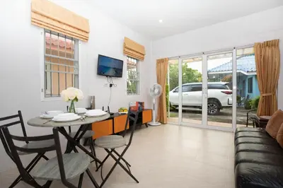 a living room with a table and chairs and a couch at cozy Best house with garden near Bang Tao beach in Ban Thalat Choeng Thale