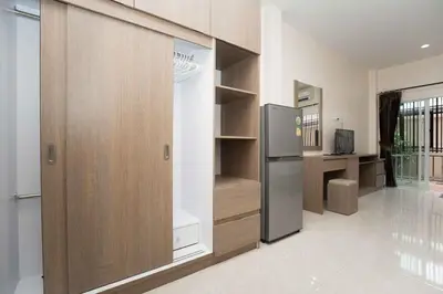 a kitchen with a refrigerator in a room at RICH house in Ban Thalat Choeng Thale