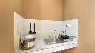 a kitchen counter with a sink and utensils at RICH house in Ban Thalat Choeng Thale