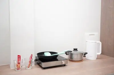 a kitchen counter with a pot and a pan on it at Cozy Bonaparte Studios in Ban Thalat Choeng Thale
