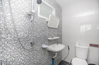 a bathroom with a shower and a toilet and a sink at VISUT apartments near mountain in Ban Thalat Choeng Thale