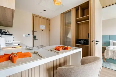 a kitchen with a counter with orange decorations on it at Laya Resort Garden Escape- Tropical Serenity Suite in Layan Beach