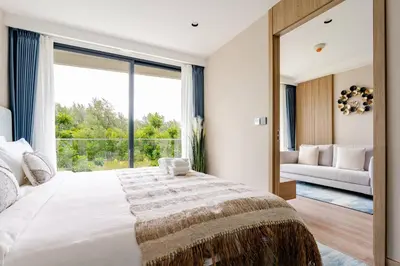 a bedroom with a large bed with a large window at Laya Resort Garden Escape- Tropical Serenity Suite in Layan Beach