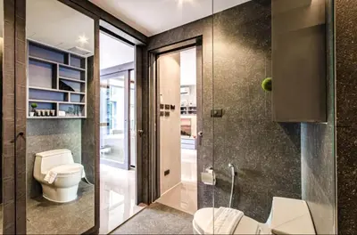 a bathroom with a toilet and a walk in shower at Tropical bliss & serenity in CityGate Resort near Kamala Beach in Phuket Town