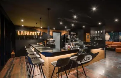 a bar with a bunch of stools in a room at Tropical bliss & serenity in CityGate Resort near Kamala Beach in Phuket Town