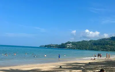 a group of people in the water at a beach at Tropical bliss & serenity in CityGate Resort near Kamala Beach in Phuket Town
