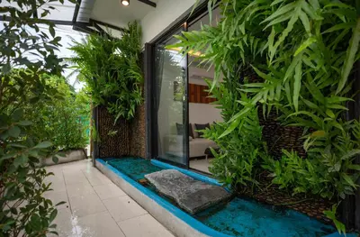 a house with a pool in the middle of a garden at Waterfall House, 800 m to the Bang Tao beach in Ban Thalat Choeng Thale