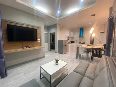 a living room with a couch and a table and a kitchen at Cozy 2-bedrooms houses complex DIN, Bang Tao beach in Ban Thalat Choeng Thale