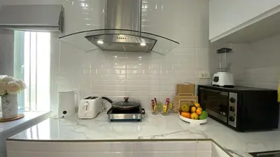 a kitchen counter with a toaster and a bowl of fruit at Cozy 2-bedrooms houses complex DIN, Bang Tao beach in Ban Thalat Choeng Thale