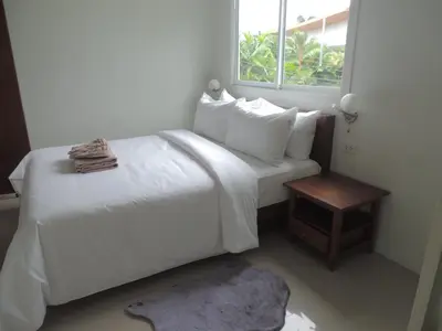 a bedroom with a white bed and a window at The Trend Villa in Kamala Beach