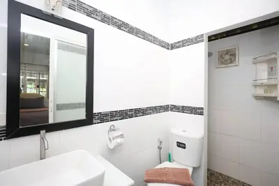 a white bathroom with a sink and a mirror at BAN House, Bang Tao beach in Ban Thalat Choeng Thale