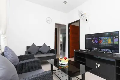 a living room with a couch and a television at BAN House, Bang Tao beach in Ban Thalat Choeng Thale