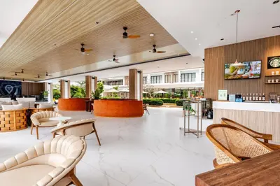 a lobby of a hotel with chairs and tables at Laya Resort -Tropical Studio in Layan Beach