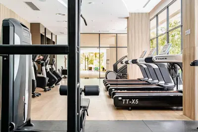 a gym with a row of treadmills at Laya Resort -Tropical Studio in Layan Beach