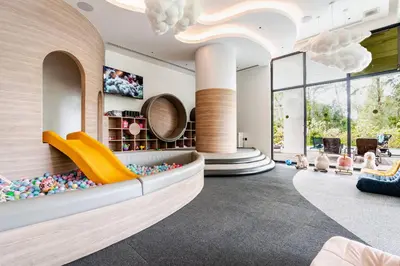 a lobby with a waiting area with a couch and lots of windows at Laya Resort -Tropical Studio in Layan Beach