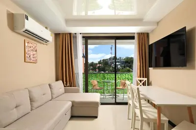 a living room with a couch and a table at Comfy 1-BR room Mountain View, 5 min to Rawai Beach in Phuket Town