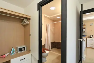 a bathroom with a toilet and a shower at Comfy 1-BR room Mountain View, 5 min to Rawai Beach in Phuket Town