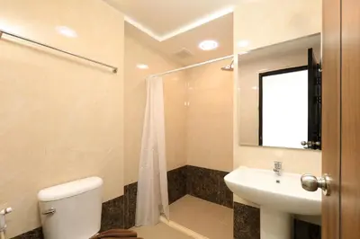 a bathroom with a white toilet and a sink at Comfy 1-BR room Mountain View, 5 min to Rawai Beach in Phuket Town