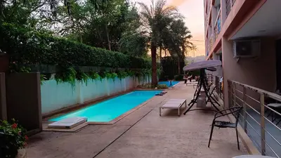 a swimming pool next to a building at Comfy 1-BR room Mountain View, 5 min to Rawai Beach in Phuket Town
