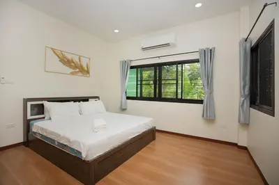 a bedroom with a bed and a window at 2 bedrooms house GREEN SALLY in Patong Beach