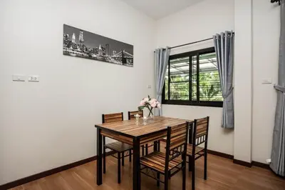 a dining room with a wooden table and chairs at 2 bedrooms house GREEN SALLY in Patong Beach