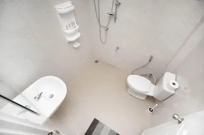 a white bathroom with a toilet and a sink at 2 bedrooms house GREEN SALLY in Patong Beach