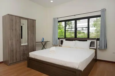 a bedroom with a large bed and a large window at 2 bedrooms house GREEN SALLY in Patong Beach