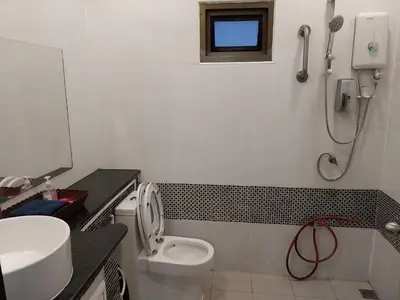 a bathroom with a toilet and a sink and a shower at House in the heart of Kamala in Kamala Beach