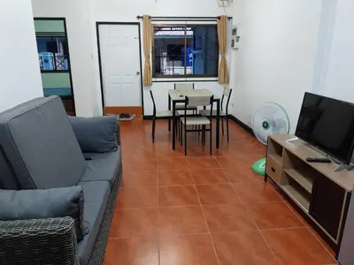 a living room with a couch and a table at House in the heart of Kamala in Kamala Beach
