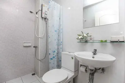 a bathroom with a toilet and a sink and a shower at Zcape 1 bedroom apartment in Ban Thalat Choeng Thale