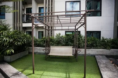 a swing in front of a building at Zcape 1 bedroom apartment in Ban Thalat Choeng Thale