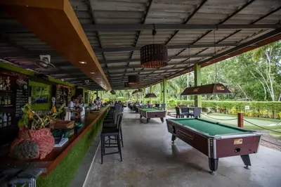 a restaurant with a pool table in the middle at Zcape 1 bedroom apartment in Ban Thalat Choeng Thale