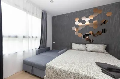 a bedroom with a bed and a wall with hearts at Zcape 1 bedroom apartment in Ban Thalat Choeng Thale