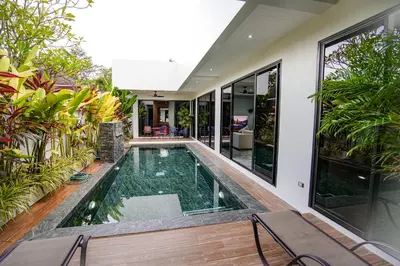 an indoor pool in a house with plants at Suwali Villa - 3 Bedroom Private Pool Villa in Ban Saiyuan (1)