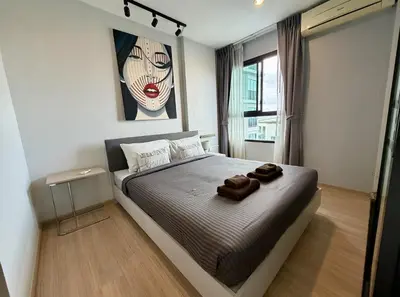 a bedroom with a bed with two towels on it at Z cape 1 one one in Laguna Phuket