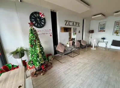 a living room with a christmas tree and a clock at Z cape 1 one one in Laguna Phuket