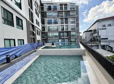 a swimming pool in the middle of a building at Z cape 1 one one in Laguna Phuket