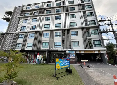 a large building with a sign in front of it at Z cape 1 two two in Ban Thalat Choeng Thale