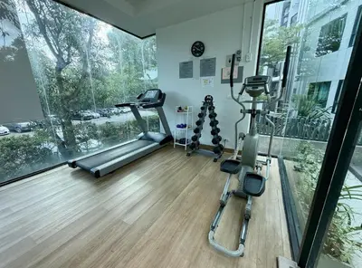 a gym with two tread machines and a large window at Z cape 1 two two in Ban Thalat Choeng Thale