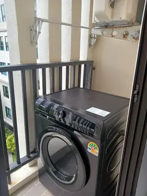 a washing machine in a room with a window at Z cape 1 two two in Ban Thalat Choeng Thale