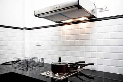 a kitchen with a stove with pots and pans at Beautiful apartment in Ban Thalat Choeng Thale
