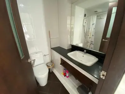 a bathroom with a toilet and a sink and a mirror at Kris condo in Patong Beach