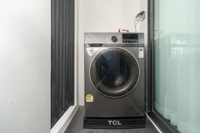 a washing machine in a room next to a window at Apartments Bellevue Lagoon Phuket near Laguna in Phuket