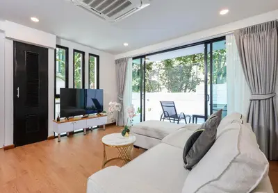 a living room with a white couch and a tv at 3BR Pool Villa with Jacuzzi near Patong - 8 Guests in Kathu