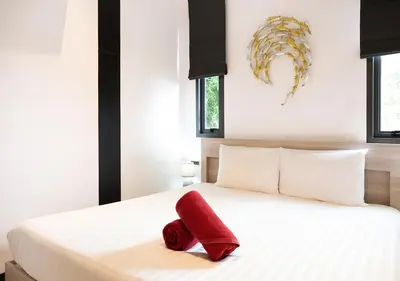 a red towel sitting on top of a bed at Sleek Designed Sunset Garden Villa 05 - 4 BR with Salt Private Pool 12M in Ban Saiyuan (1)