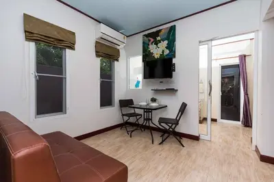 a living room with a couch and a table at KUM house in Laguna Phuket