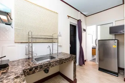 a kitchen with a sink and a refrigerator at KUM house in Laguna Phuket