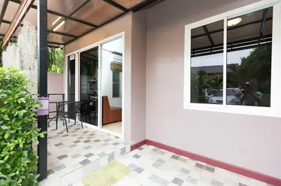 a house with a glass door and a patio at KUM house in Laguna Phuket